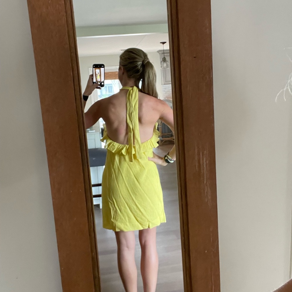 Halter backless dress with ruffle detail.